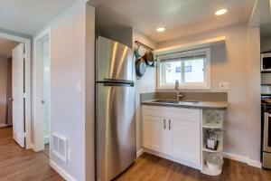 a kitchen with a stainless steel refrigerator and a sink at Bette's Bungalow in San Diego +20 photos