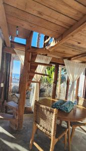 a wooden table and chairs in a room with windows at Villas Manchineel in Sayulita