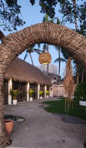 a wicker archway with a chandelier in front of a building at Villas Manchineel in Sayulita