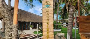 a wooden sign in front of a resort at Villas Manchineel in Sayulita