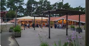 a group of people standing outside of a building at Mobil-home MJ in Seignosse