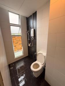 a bathroom with a toilet and a phone on the wall at Peace Homestay 2 in Brinchang