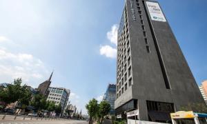 a tall building in the middle of a city at Dobong Hotel Bay204 in Seoul