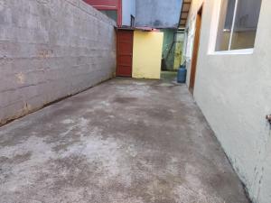 an empty parking lot next to a brick wall at Casa Manaba in Baños