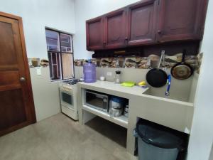a kitchen with brown cabinets and a counter top at Casa Manaba in Baños