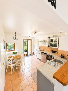 a kitchen and dining room with a table and chairs at Eirene Retreat - Quiet Riverside Escape in Upper Hutt