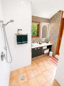 a bathroom with a shower and a sink at Eirene Retreat - Quiet Riverside Escape in Upper Hutt