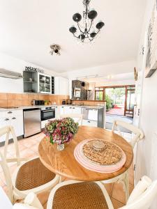 a kitchen with a wooden table and chairs at Eirene Retreat - Quiet Riverside Escape in Upper Hutt +17 photos