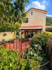 a house with a staircase leading to the front yard at Eirene Retreat - Quiet Riverside Escape in Upper Hutt