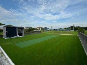 a large yard with a green field of grass at N's villa in Kujukuri