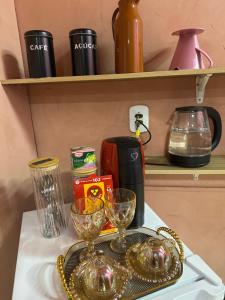a tray with wine glasses on a shelf at Quarto próximo ao parque de exposição BR163 in Dourados