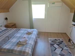 a bedroom with a bed with two towels on it at Horizont Cemerno in Podborina