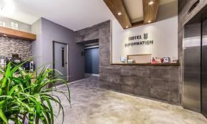 a lobby of a hotel with a hotel management sign on the wall at Chuncheon Hotel View in Chuncheon