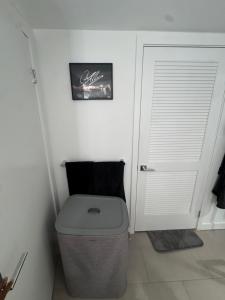 a bathroom with a toilet and a white door at Luxury Loft 1BR Steps Away from Santa Monica Pier in Los Angeles