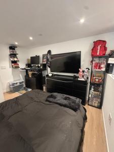 a bedroom with a bed and a flat screen tv at Luxury Loft 1BR Steps Away from Santa Monica Pier in Los Angeles +6 photos