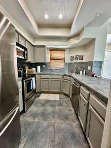 a kitchen with stainless steel appliances and a window at Our Mountain View in Tucson