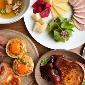 a table topped with plates of food with breakfast foods at Lemeraude BnB in Hengchun South Gate +18 photos