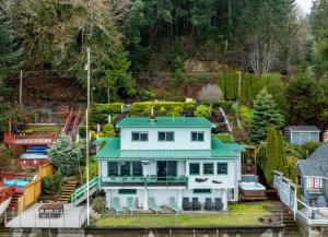 a large white house with a green roof at Oyster Oasis in Tahuya