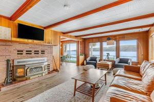a living room with a couch and a fireplace at Oyster Oasis in Tahuya +33 photos