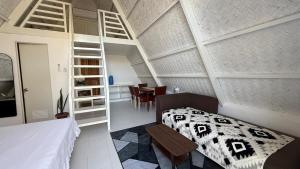 a bedroom with a bed and a dining room at Cabin Corazon in Coron +5 photos