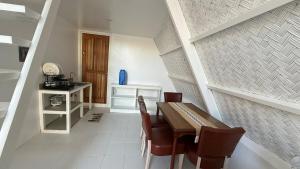 a dining room with a table and chairs at Cabin Corazon in Coron