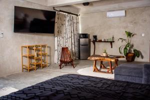 a living room with a couch and a table at La Familia Casa and Suites in Holbox Island