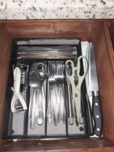 a drawer filled with utensils in a drawer at Riverside Oasis Cabin with A C in Guápiles