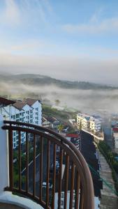 a view from a balcony of a city with fog at Crown imperial in Brinchang