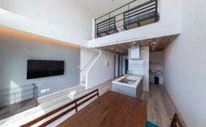 a large living room with a sink and a tv at Tabinoteitaku Y-beach in Tsuruoka