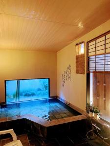 a room with a large aquarium in the corner of a room at Good Stay Mizuho in Usa
