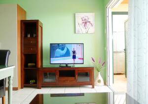 a living room with a flat screen tv on a cabinet at Luxury Apartment Balcon de Jandía in Morro del Jable