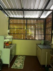 a kitchen with a counter and a sink in a room at บ้านชมธาร บ้านสวนสราญชล in Ban Plai Nam (2) +2 photos