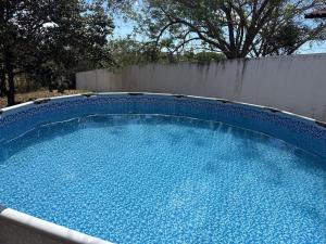a large blue swimming pool in a backyard at Villa Rosita in San Carlos +17 photos