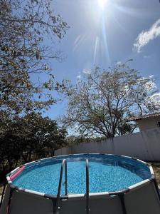 a blue swimming pool with the sun in the sky at Villa Rosita in San Carlos