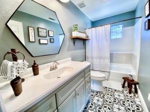 a bathroom with a sink and a toilet and a mirror at Sunset Site Boulder Bliss HotTub by Casa Oso in Ahwahnee +38 photos