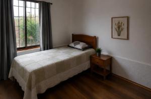 a bedroom with a bed and a window at Estrella rooms La Florida in Santiago