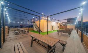 a deck with benches and tables on a building at Donghae Gloria Hotel in Donghae