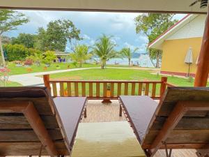 a porch with two chairs and a bench at Rimlay Bay View 2 in Ko Yao Noi