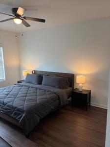 a bedroom with a bed and a ceiling fan at Brand new condo right off the interstate in Berea