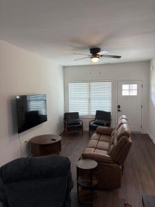 a living room with a couch and a flat screen tv at Brand new condo right off the interstate in Berea
