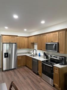 a kitchen with wooden cabinets and stainless steel appliances at Brand new condo right off the interstate in Berea