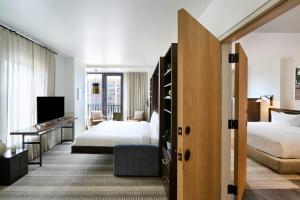 a hotel room with two beds and a desk at Halcyon, a hotel in Cherry Creek, Denver in Denver +64 photos