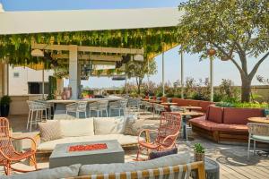 a patio with couches and tables and chairs at Halcyon, a hotel in Cherry Creek, Denver in Denver
