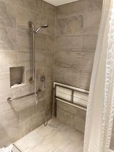 a bathroom with a shower with a shower curtain at Esplanade Hotel Busselton in Busselton +19 photos