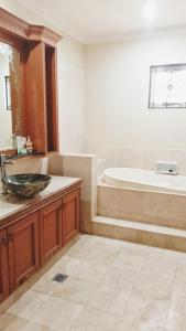 a bathroom with a tub and a sink at Vila Princess Sentul 7 bedroom Private pool, Billiard, Tenis meja in Babakan Madang +18 photos