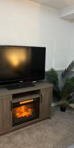 a television on top of a fireplace in a living room at Aurora Nights in Fairbanks
