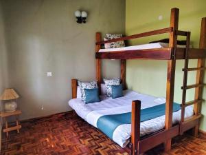 a bedroom with two bunk beds in a room at VILLA LEELA's WITH HOME THEATRE in Kodaikānāl