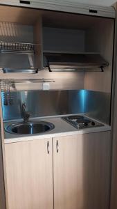a kitchen with a sink and a stove at City Point Chios in Chios