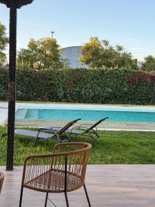 a couple of chairs sitting next to a swimming pool at Chateau Montchenot in Maipú
