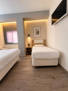 a bedroom with two beds and a window at HOSTAL LETTO DAL MARE in Valencia +32 photos